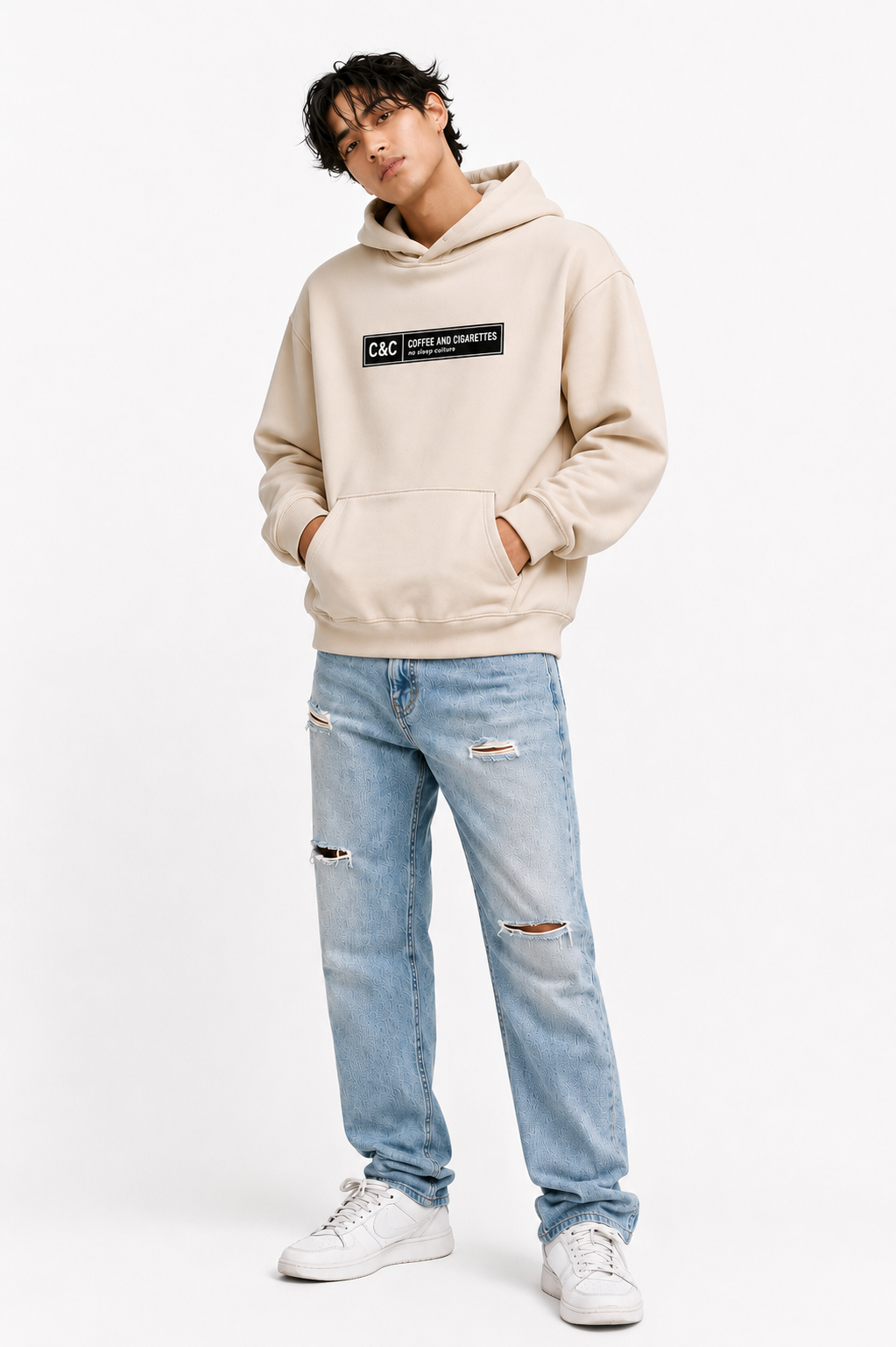 male model casual front pose wearing oversized beige graphic streetwear hoodie minimal chest logo urban streetwear outfit
