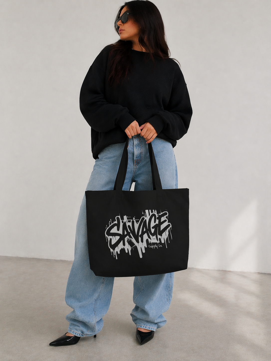 model front view carrying black tote bag savage logo casual urban streetwear outfit