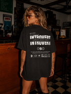woman viewed from back wearing oversized black graphic t shirt featuring Introvert statement back print urban streetwear fashion
