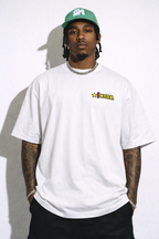 male model front view wearing oversized white graphic streetwear t shirt MYOB chest logo design urban streetwear outfit
