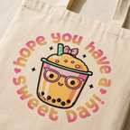 model close-up detail beige tote bag kawaii bubble tea design sweet day typography soft lighting fabric texture