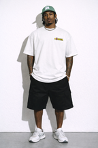 male model full body front view wearing oversized white graphic streetwear t shirt MYOB logo design urban streetwear outfit