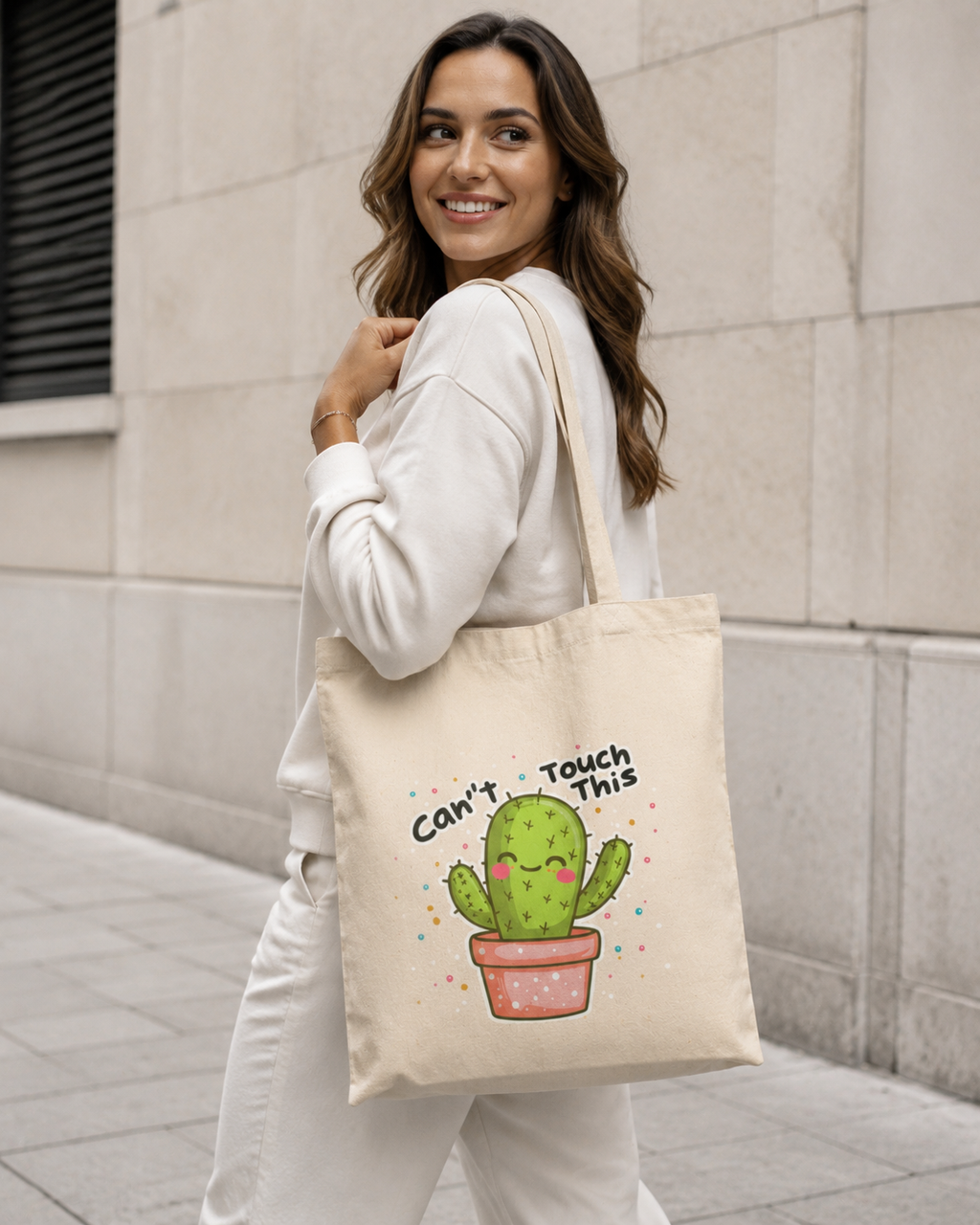 Woman wearing natural canvas Nöiré cactus tote bag over shoulder, lifestyle view
