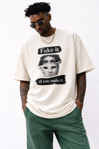 male model close front pose wearing oversized cream graphic streetwear t shirt fake it til you make it statue mask design urban streetwear outfit