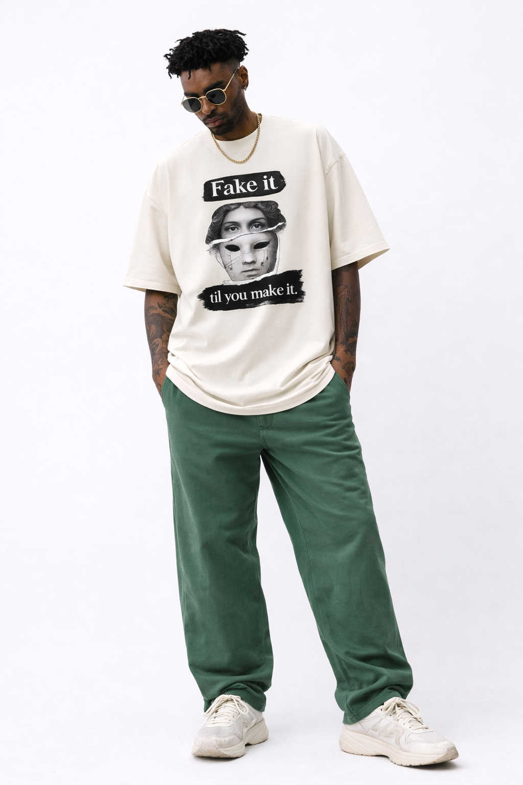male model full body front pose wearing oversized cream graphic streetwear t shirt fake it til you make it statue mask illustration streetwear fashion