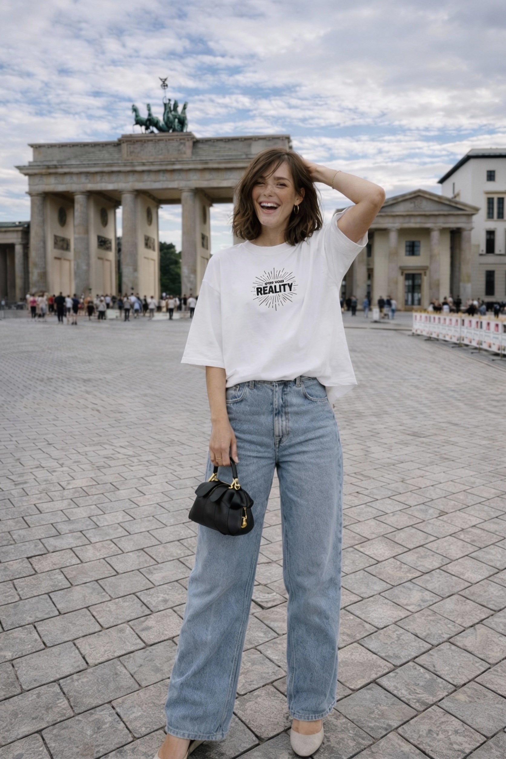 female model full body front view wearing oversized white graphic streetwear t shirt own your reality minimal graphic streetwear outfit