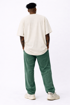 male model back view standing wearing oversized cream streetwear t shirt blank back minimalist streetwear outfit