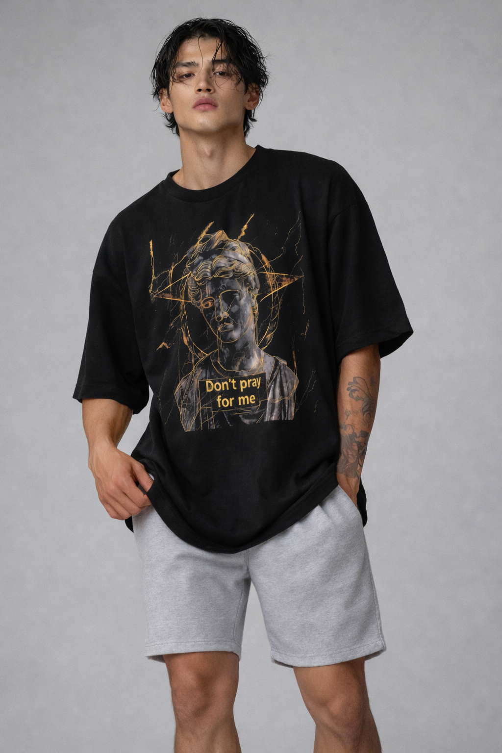 male model close front view wearing oversized black graphic streetwear t shirt david statue dont pray for me graphic streetwear fashion