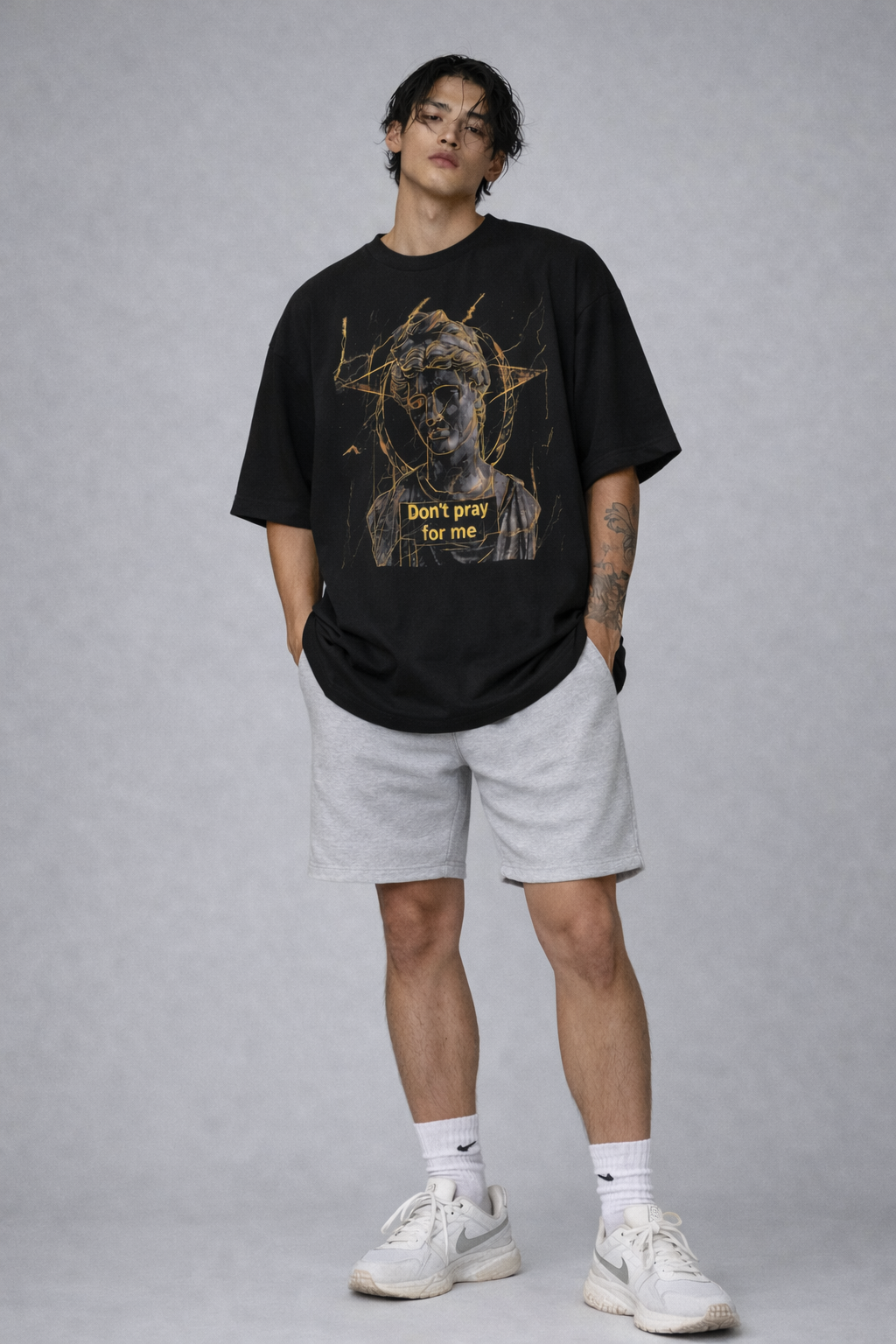 male model front pose wearing oversized black graphic streetwear t shirt david statue dont pray for me design urban streetwear outfit