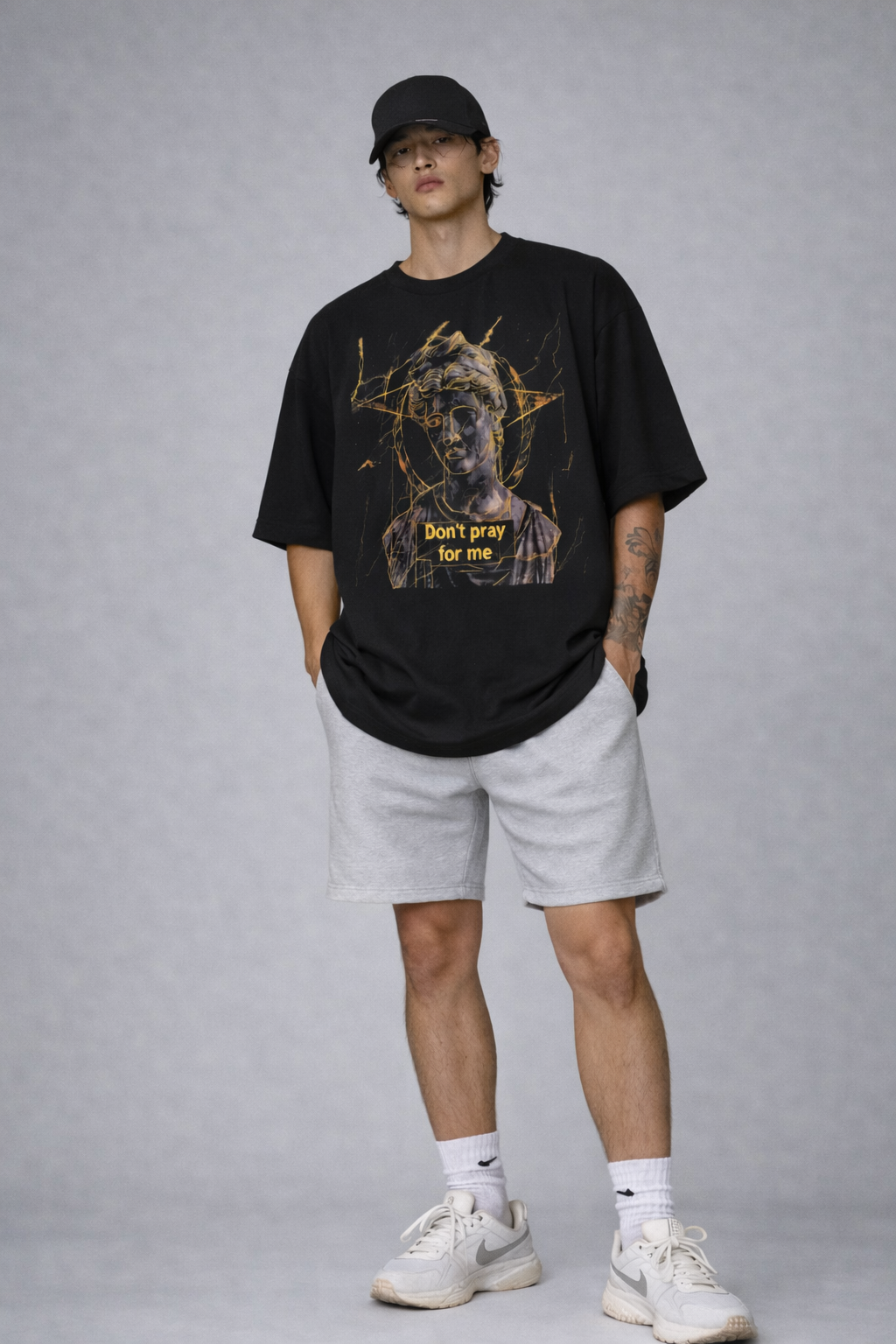male model full body front pose wearing oversized black graphic streetwear t shirt david statue dont pray for me streetwear fashion