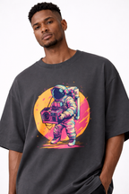 male model close up wearing oversized black graphic streetwear t shirt astronaut boombox retro sunset design streetwear fashion
