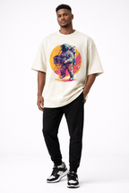 male model front pose wearing oversized beige graphic streetwear t shirt astronaut boombox retro sunset design graphic streetwear