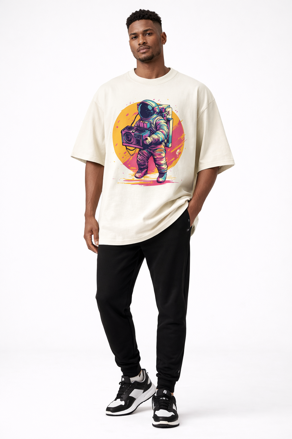 male model front pose wearing oversized beige graphic streetwear t shirt astronaut boombox retro sunset design graphic streetwear