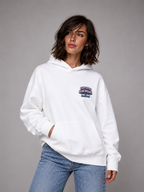model looking sideways wearing oversized white hoodie certified heartbreaker design casual streetwear fashion
