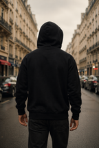 back view model standing wearing oversized black hoodie urban street paris urban streetwear outfit