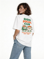 female model back view wearing oversized white graphic streetwear t shirt sushi social club kawaii sushi graphic streetwear fashion