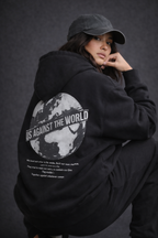 Female model back detail wearing oversized black graphic streetwear hoodie world tour typography graphic urban streetwear clothing