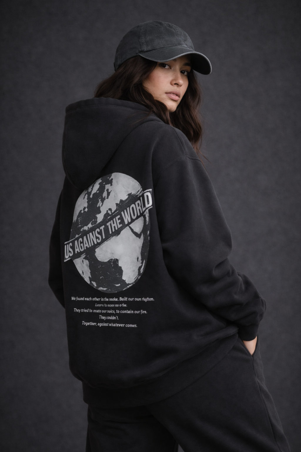 Female model back pose wearing oversized black graphic streetwear hoodie world tour graphic print urban streetwear clothing