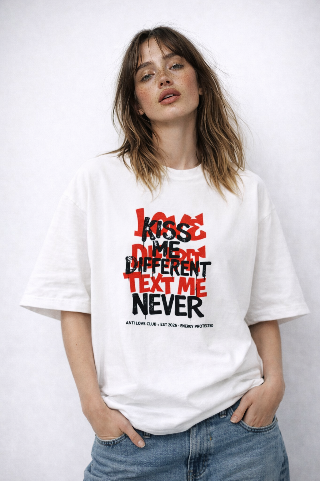 Female model wearing oversized white statement graphic t-shirt with Text Me Never streetwear design