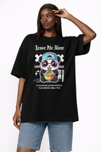 Female model wearing oversized black urban graphic t-shirt with Leave Me Alone panda noodles streetwear design