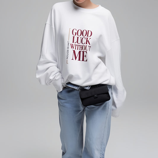 Model wearing white graphic sweatshirt with “Good Luck Without Me” typography, minimalist lifestyle studio photo