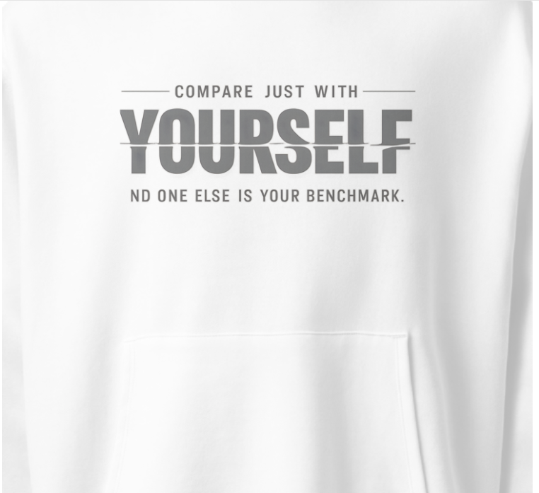Close-up of “Compare just with yourself, no one else is your benchmark” motivational typography print on white unisex hoodie
