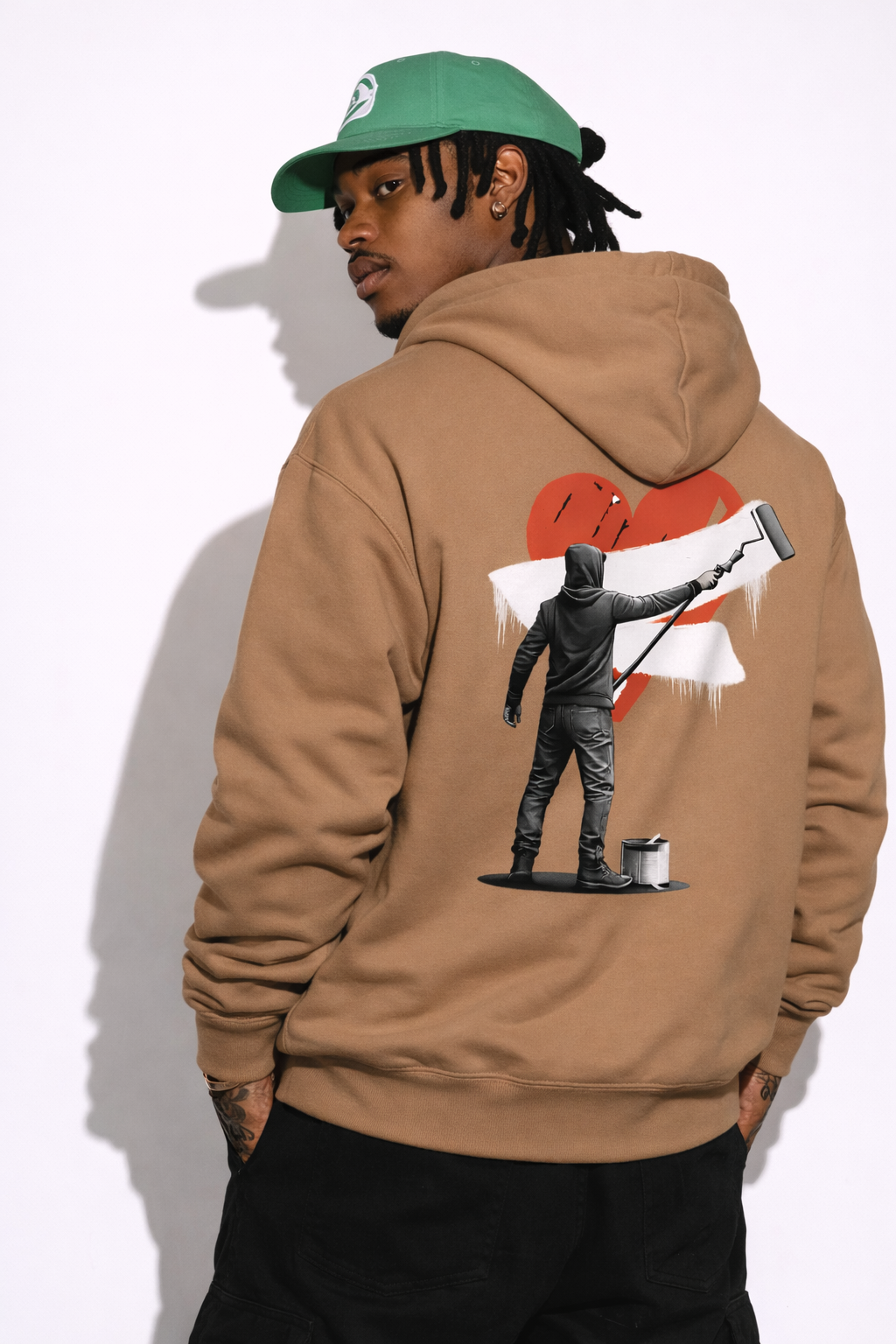 Noiré brown  oversized hoodie back view with large red heart and artistic streetwear character print, worn by male model, statement graphic hoodie.