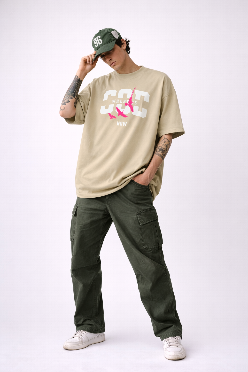 Beige oversized Noiré graphic T-shirt featuring “Where Is God Now” typography and pink bird artwork, relaxed streetwear fit.