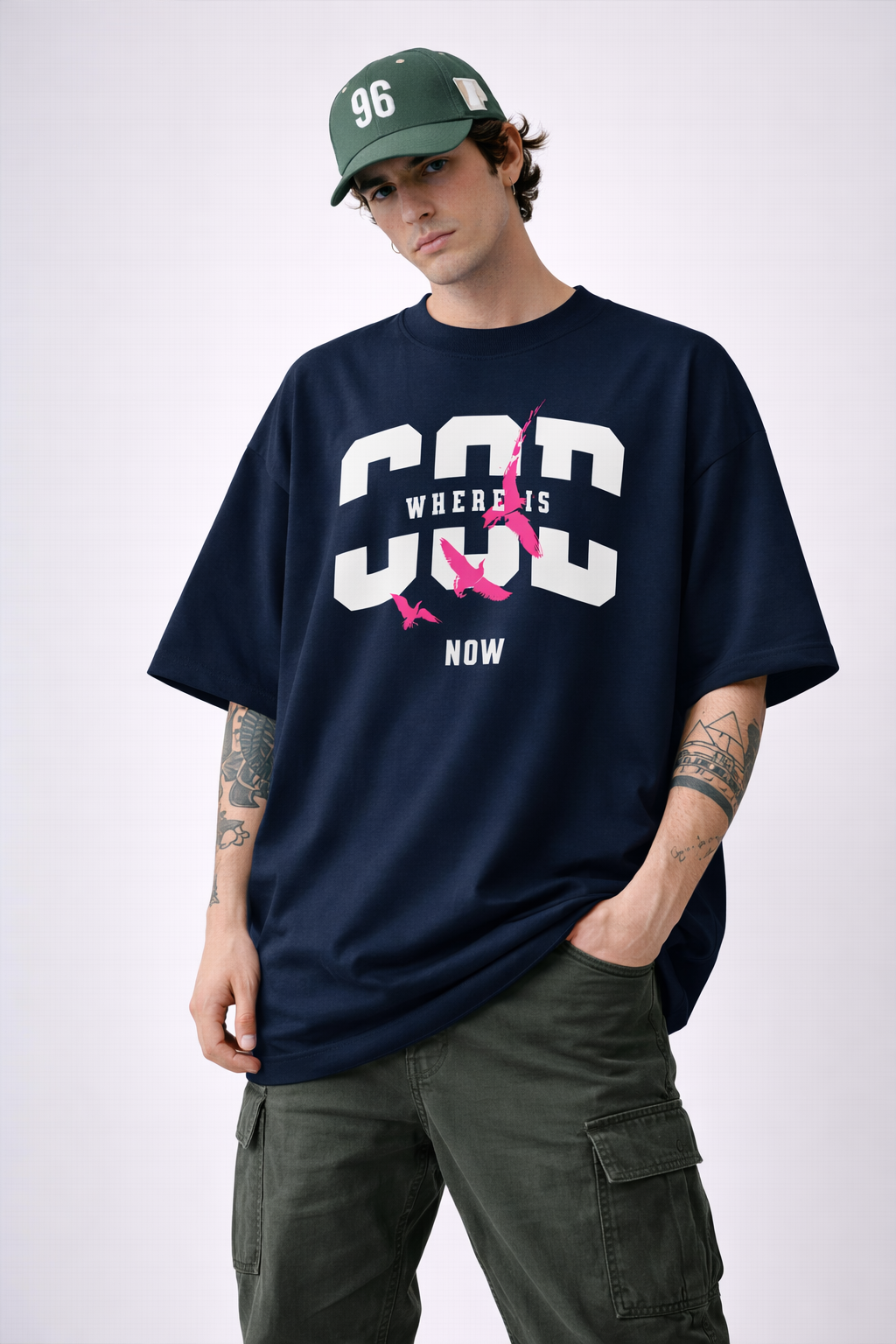 Navy blue Noiré streetwear T-shirt with “Where Is God Now” bold graphic and pink birds design, modern oversized style.