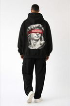 Black oversized hoodie back print with classical statue and bold red “DANGEROUS” lettering, male model full body studio image