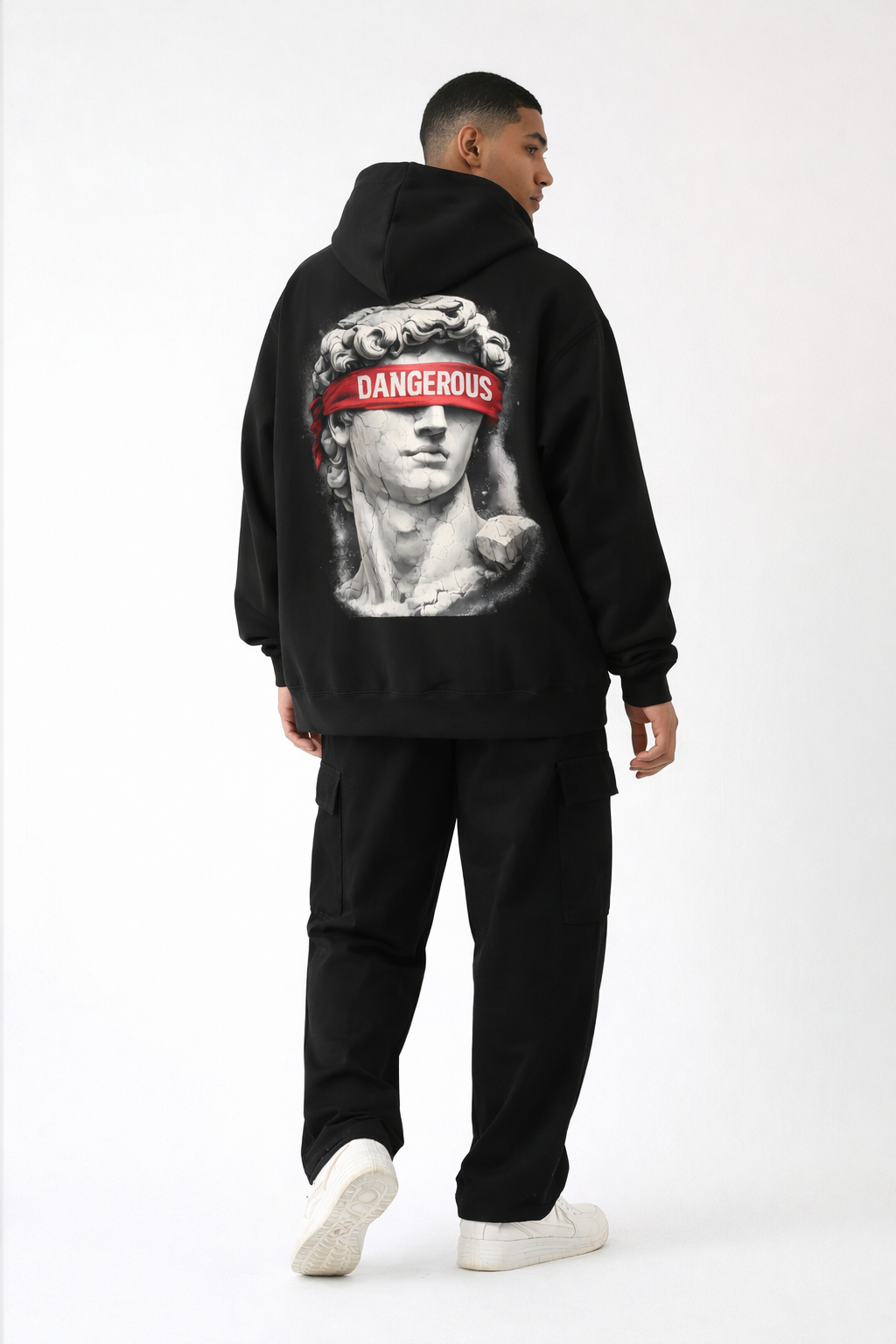 Black oversized streetwear hoodie for men with minimalist front graphic and black cargo pants, studio model full body on white background