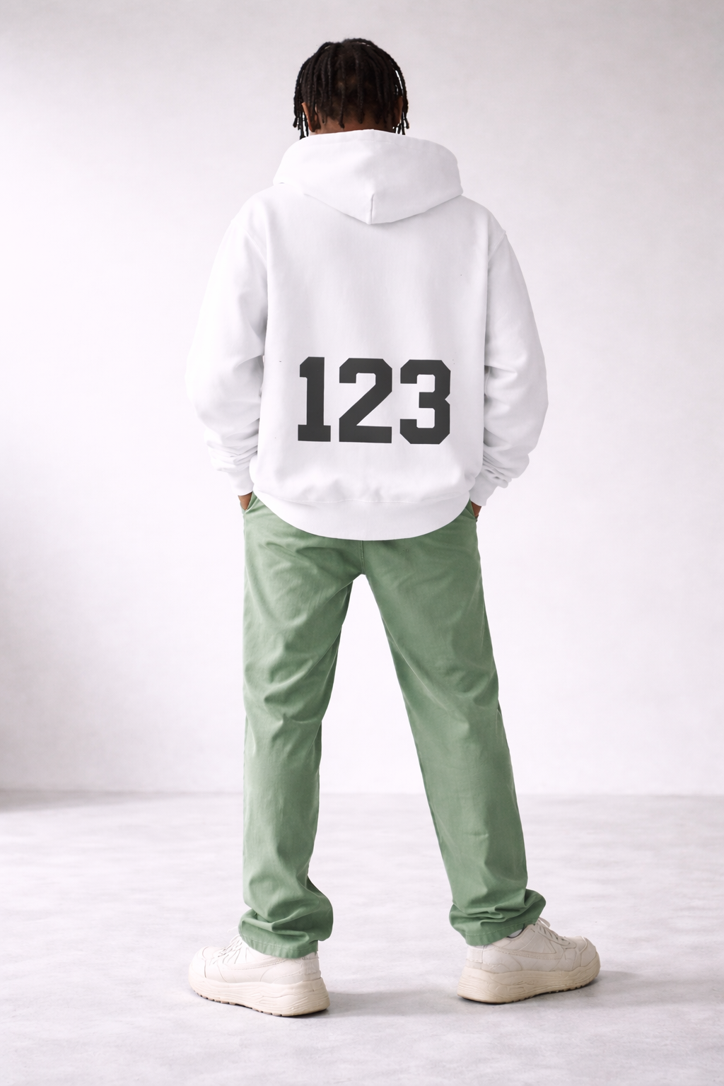 Men’s white oversized hoodie with bold “123” number print on the back, minimalist streetwear fashion sweatshirt product photo.