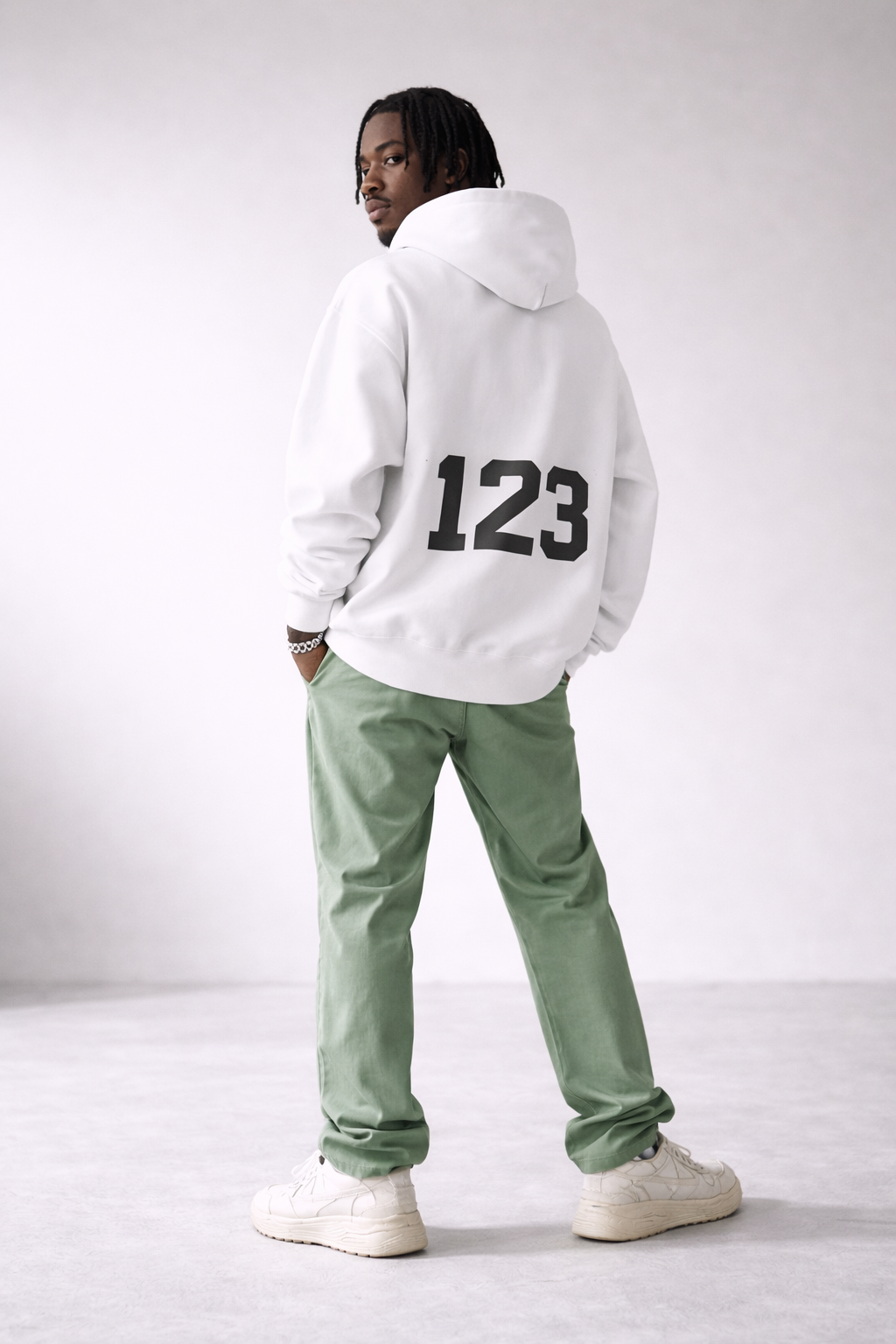 Men’s white oversized hoodie with bold “123” number print on the back, minimalist streetwear fashion sweatshirt product photo.