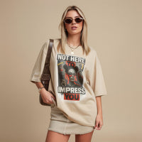 Model wearing unisex graphic t-shirt with bold typography and portrait design in a studio setting