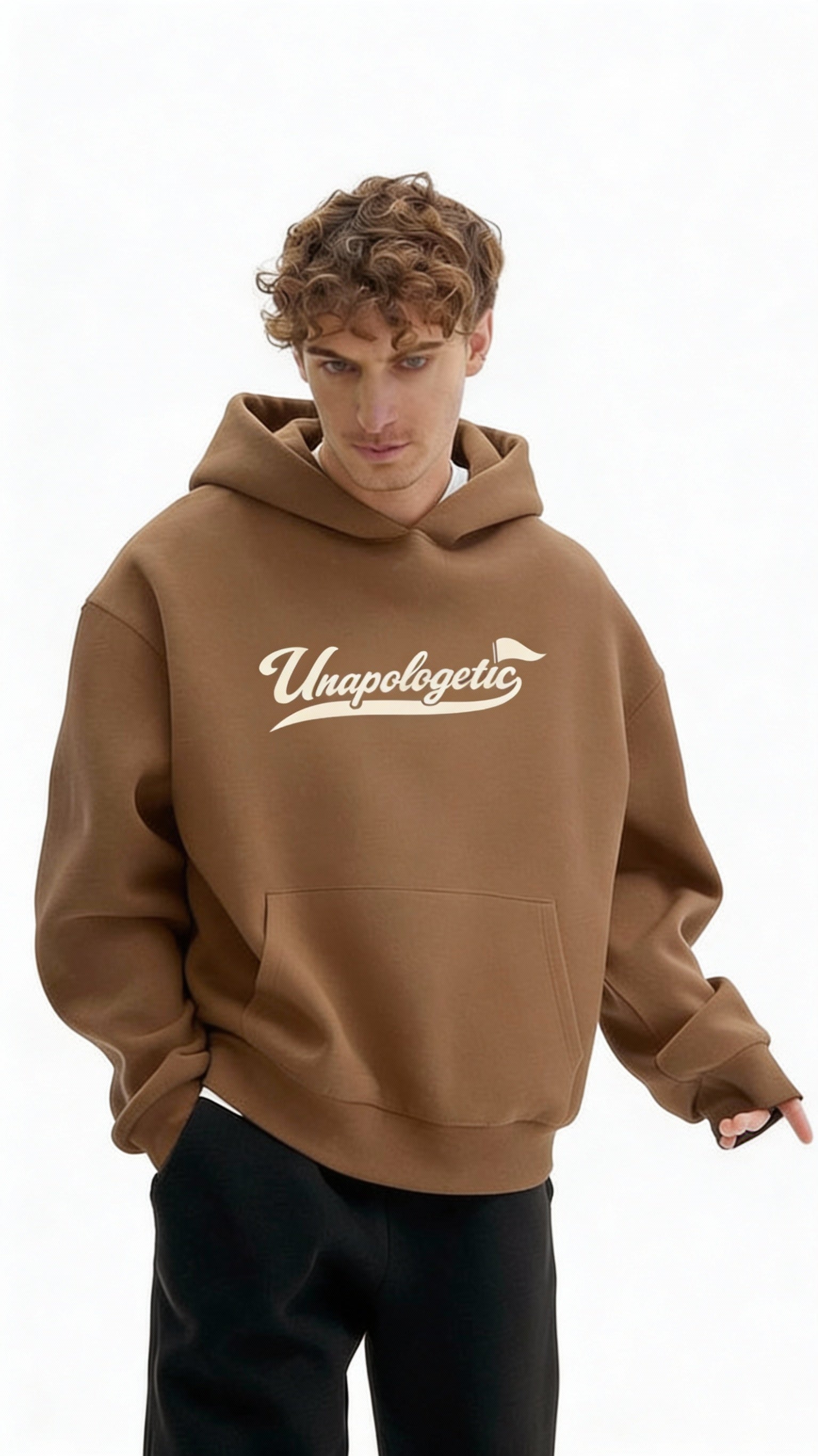 Noiré brown oversized streetwear hoodie front view with “Unapologetic” script graphic in beige, worn by male model, unisex statement hoodie.
