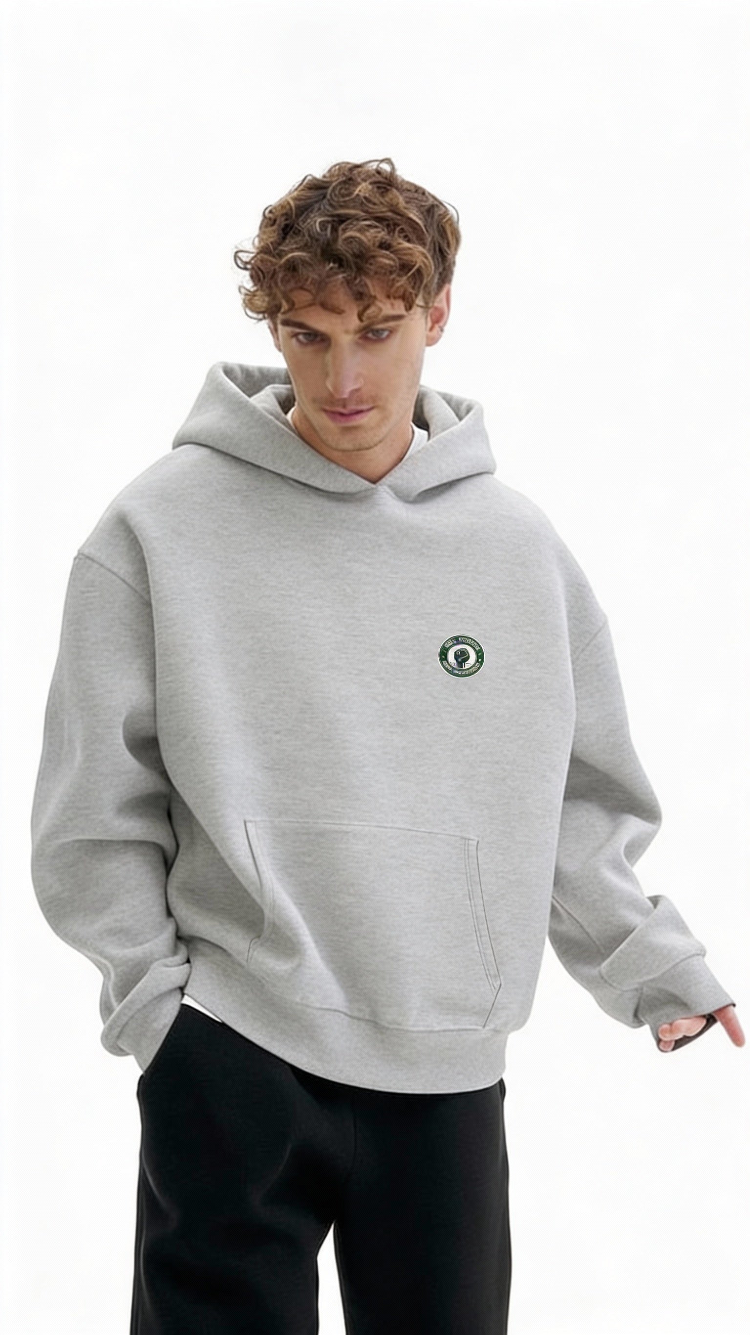 Grey oversized hoodie with small green Noiré emblem on chest, front view, unisex streetwear sweatshirt