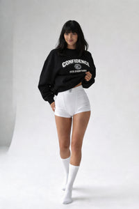 female model wearing black confidence fits everything sweatshirt front view studio shot
