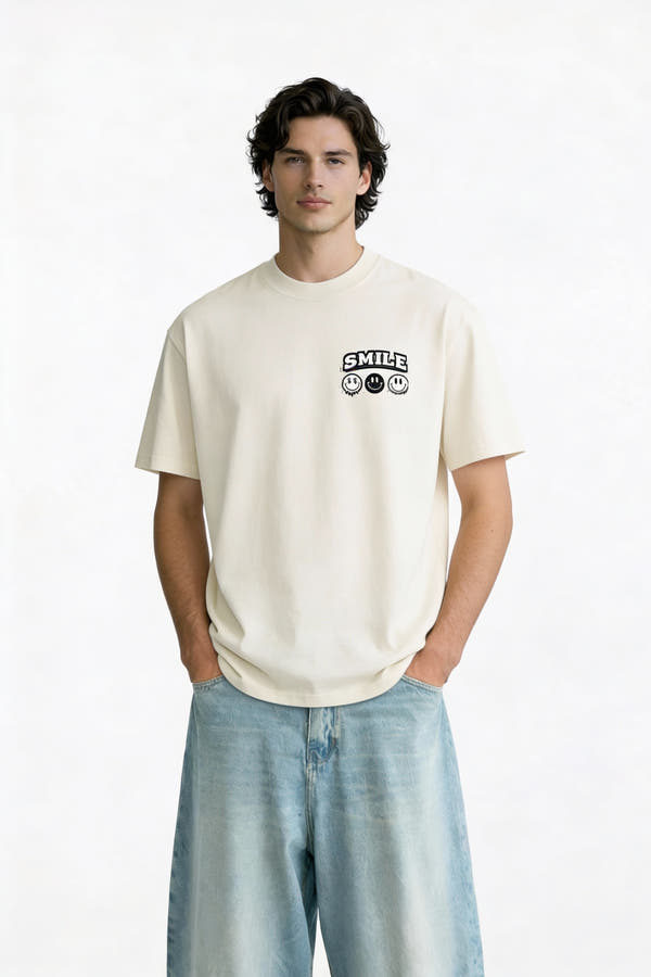 Model wearing beige t-shirt with small “Smile” chest graphic, casual modern streetwear outfit by Noiré.