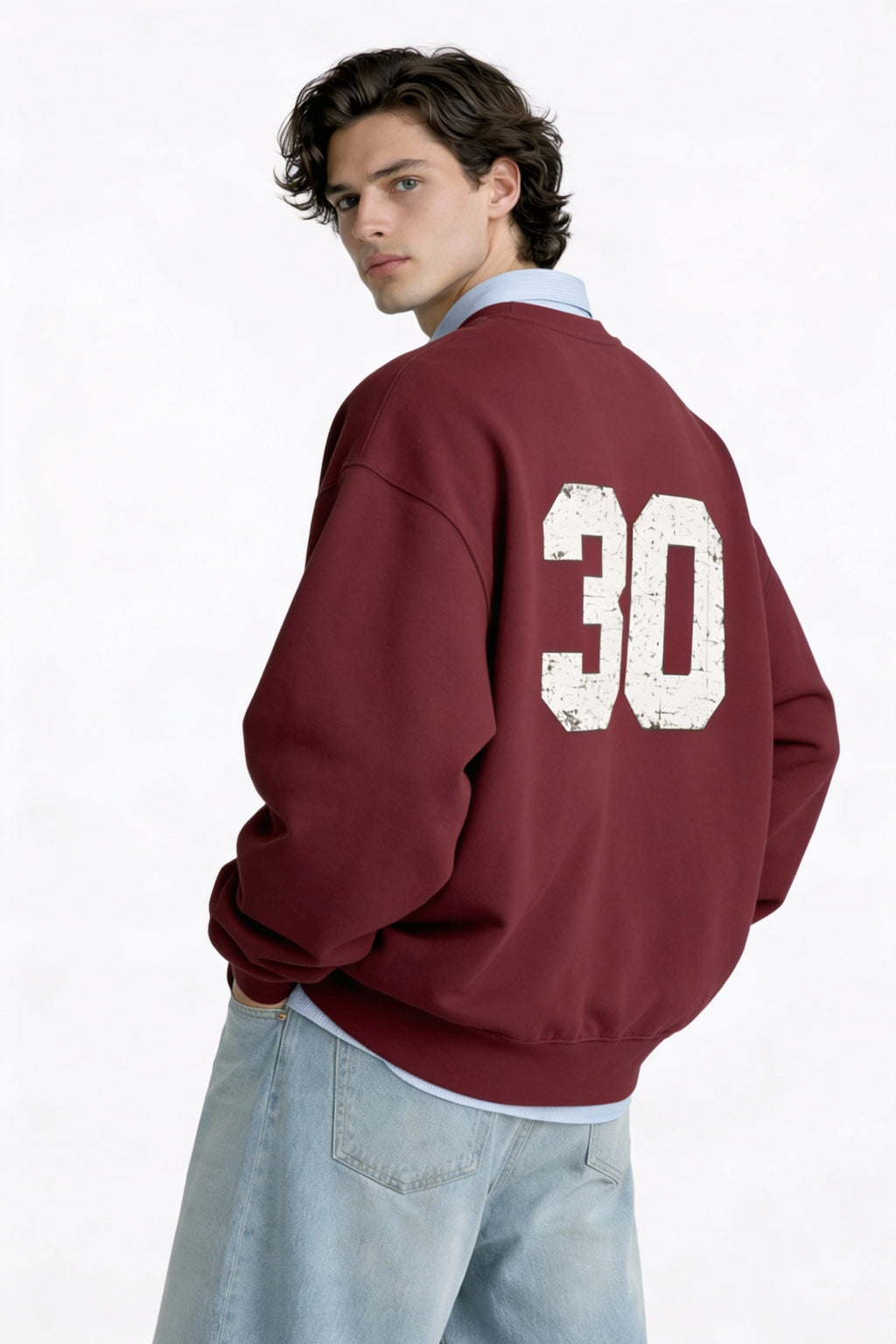 Noiré oversized burgundy sweatshirt with vintage 30 back print, male model rear view, varsity streetwear