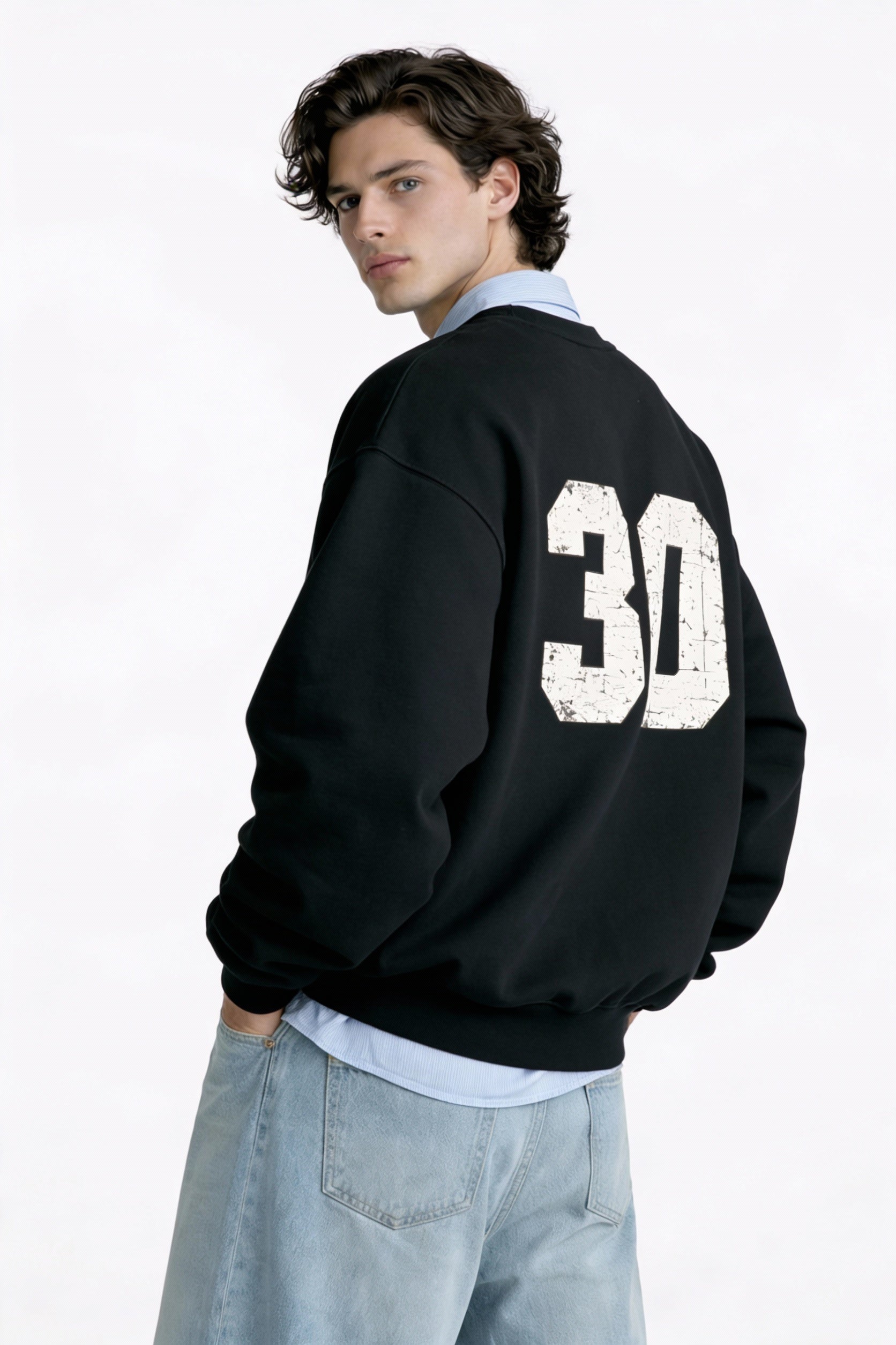 Noiré oversized black sweatshirt with distressed 30 back print, male model rear view, streetwear style