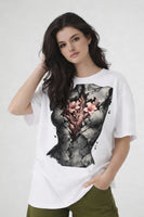 Model wearing white t-shirt with anatomical heart illustration, oversized urban streetwear look by Noiré.