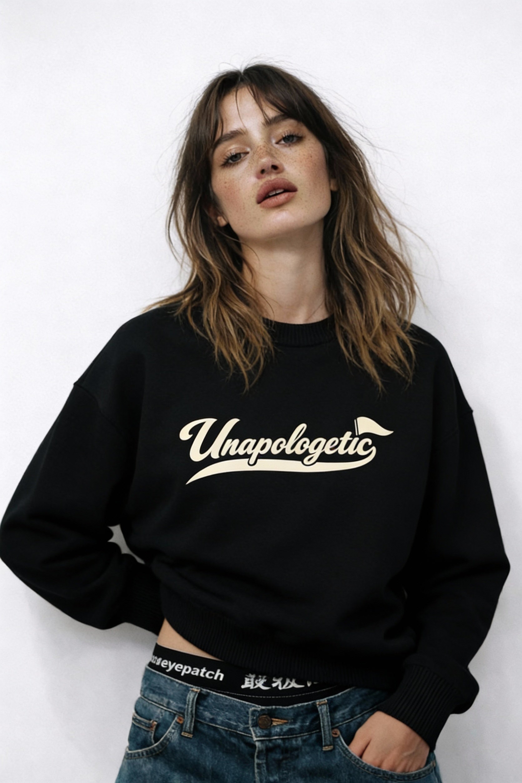 Noiré Unapologetic black oversized sweatshirt, angled front view on female model, premium streetwear aesthetic