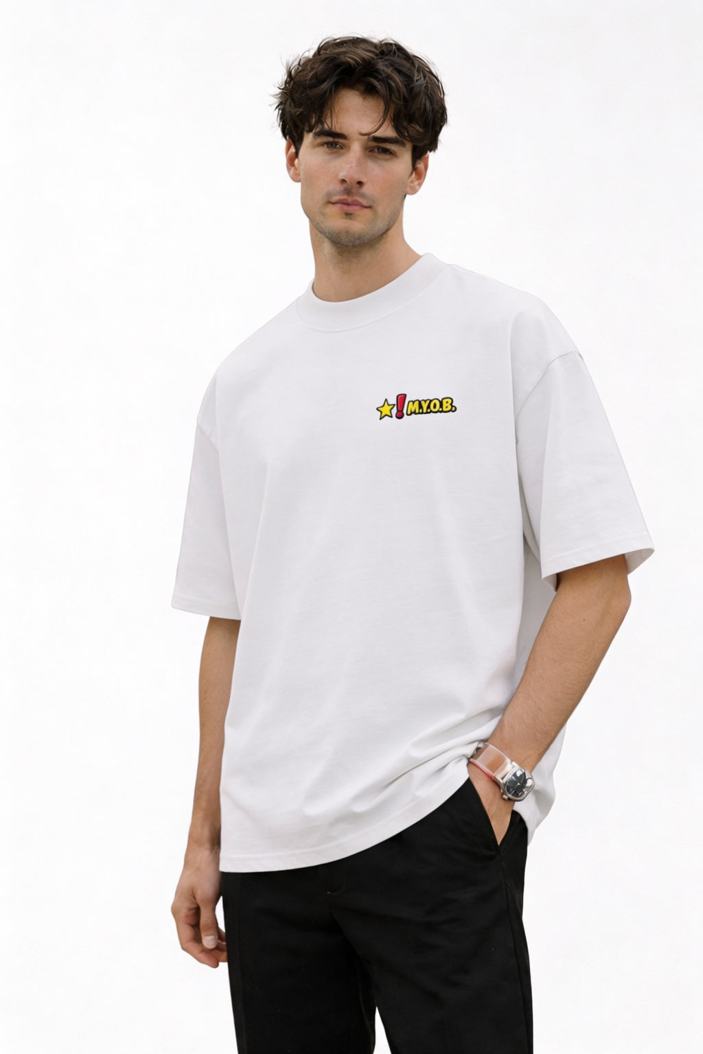 White oversized unisex T-shirt with small “MYOB” chest logo graphic, clean minimalist front design, worn by male model in studio