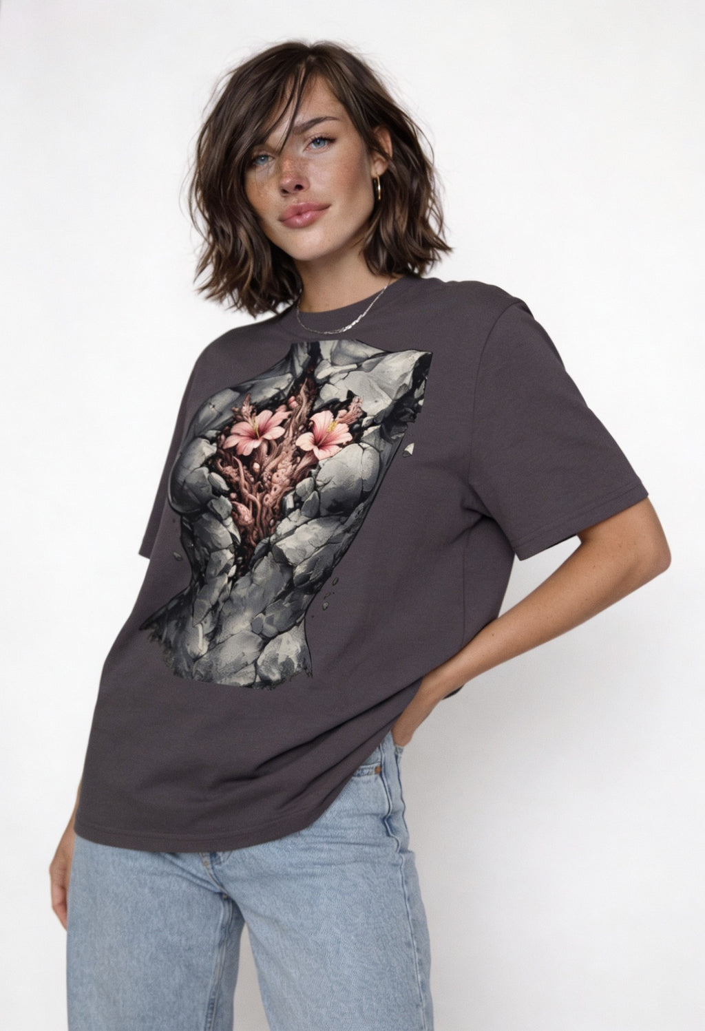Model wearing oversized grey artistic graphic t-shirt with fractured stone torso and flowers design