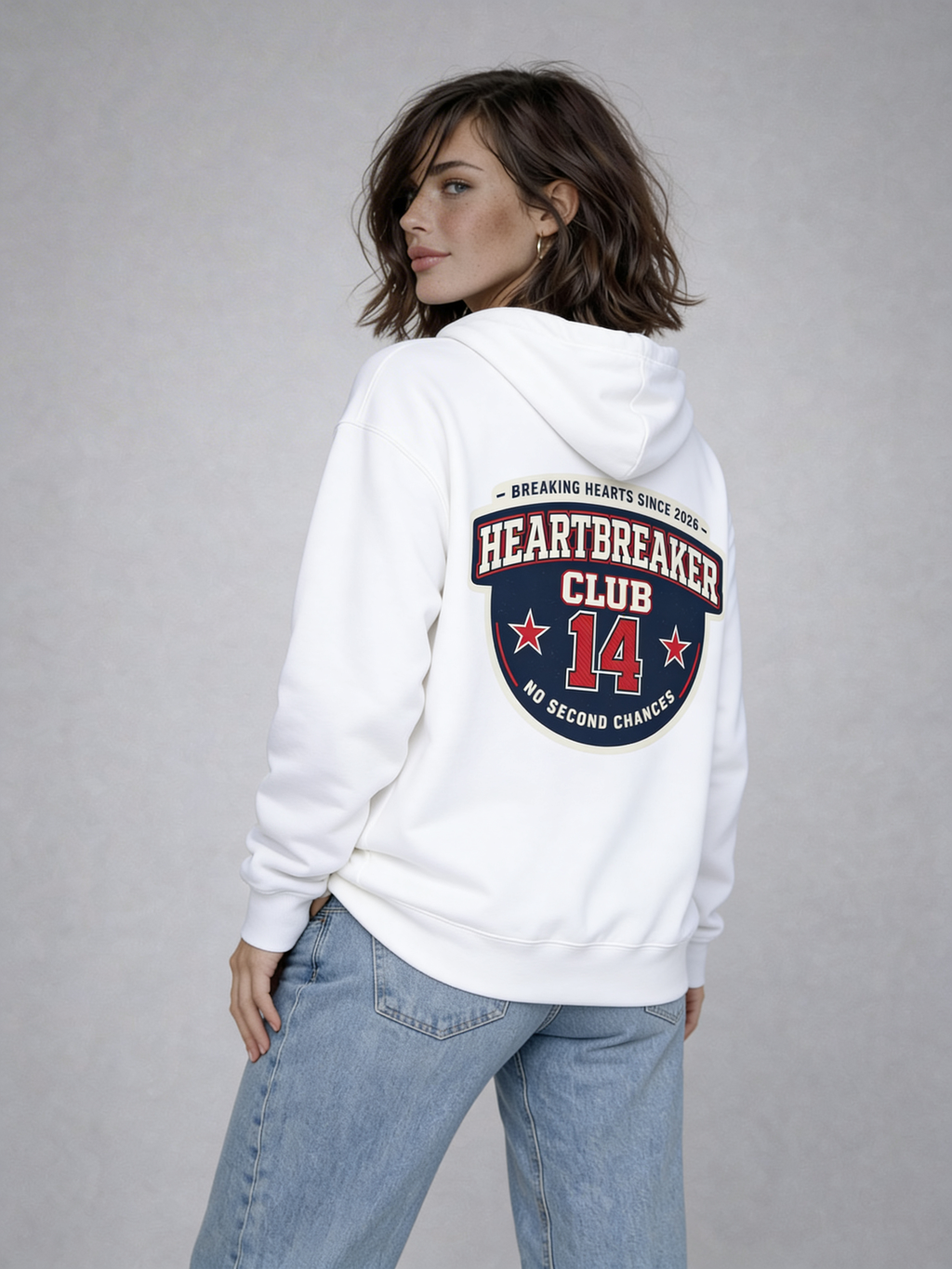 Noiré white oversized hoodie back view with “Heartbreaker Club 14” varsity graphic print in red and navy, worn by female model, streetwear Valentine collection.