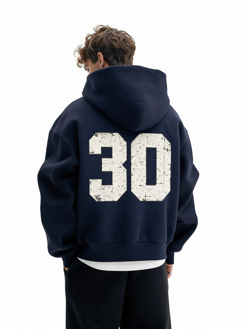 Noiré navy oversized streetwear hoodie back view with large distressed “30” varsity number print, worn by male model, urban graphic hoodie.