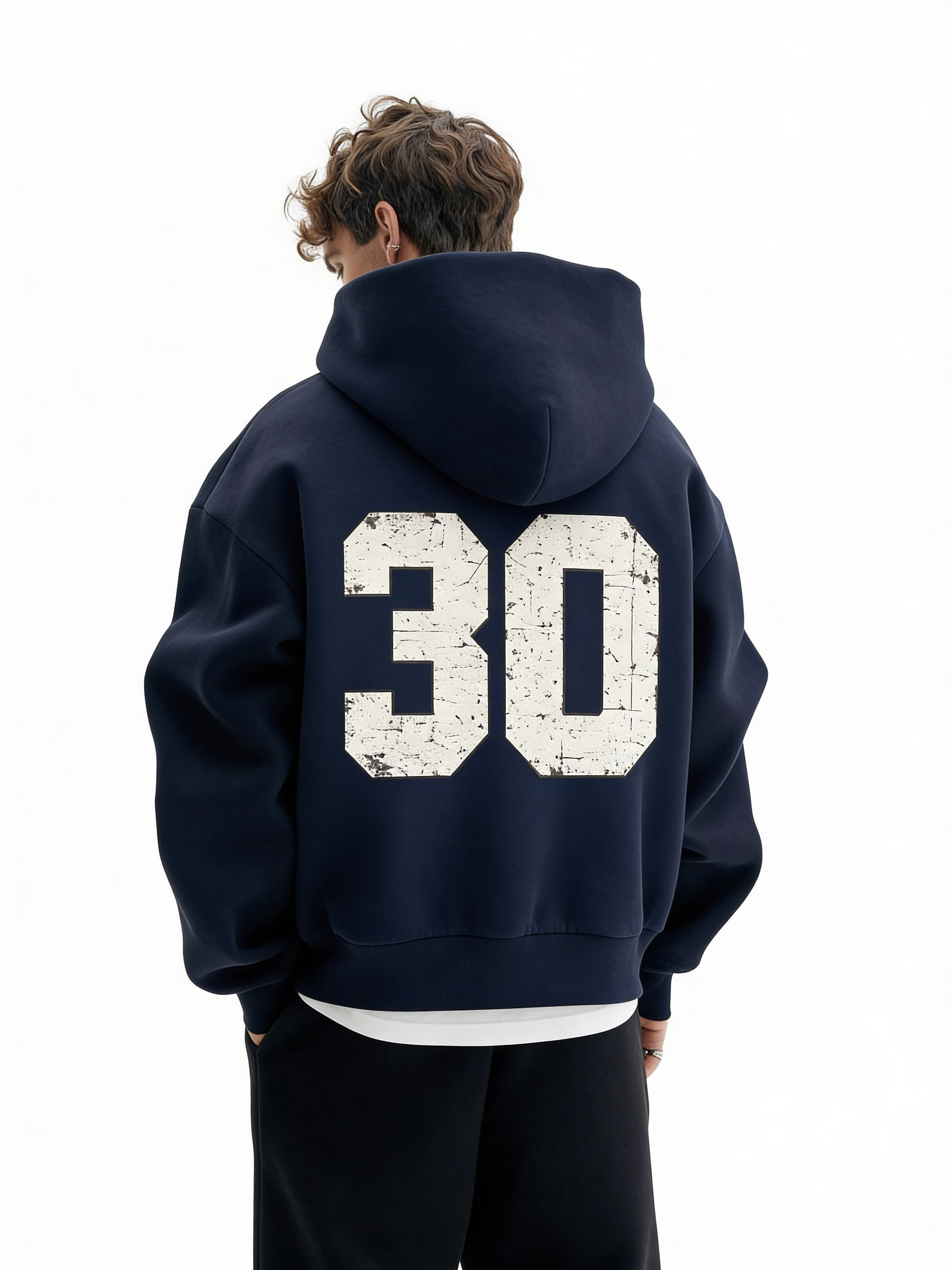 Noiré navy oversized streetwear hoodie back view with large distressed “30” varsity number print, worn by male model, urban graphic hoodie.