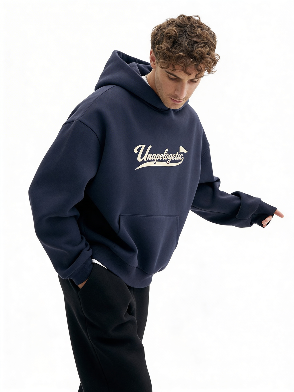 Noiré navy oversized streetwear hoodie front view with “Unapologetic” script graphic in beige, worn by male model, unisex statement hoodie.
