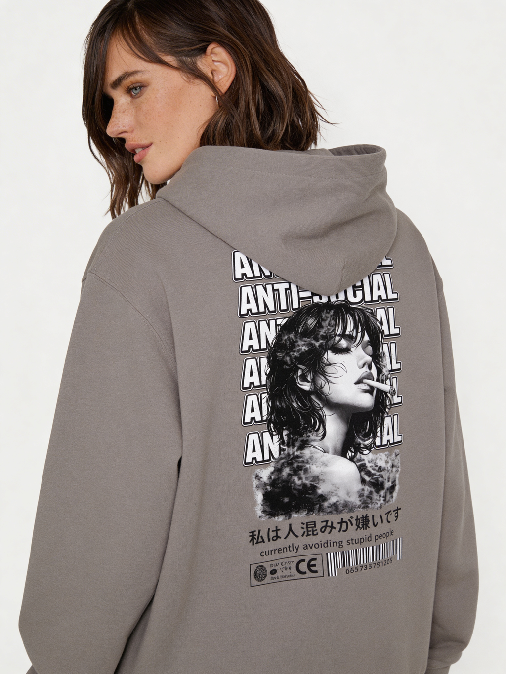 Noiré grey oversized hoodie back view with bold “Anti-Social” repeated typography and black and white portrait graphic, worn by female model, statement streetwear hoodie.