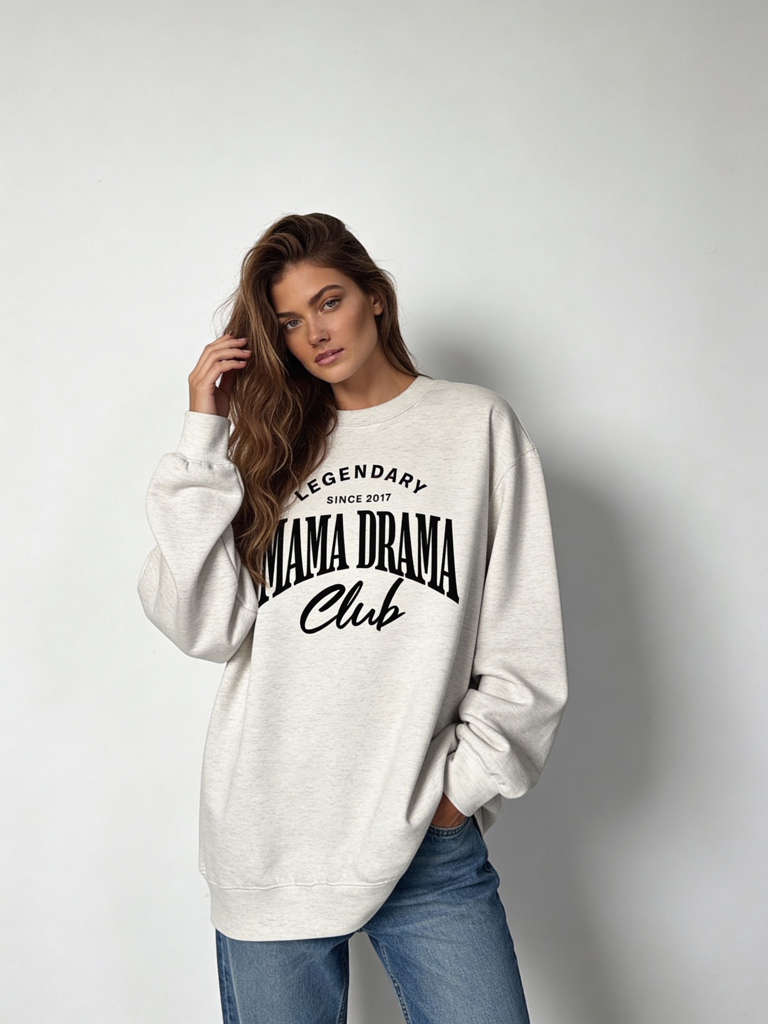Noiré Legendary Mama Drama Club oversized crewneck sweatshirt for women in oatmeal, front view, bold black typography graphic, streetwear aesthetic.